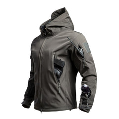 Men's outdoor Sharkskin softshell jacket in dark gray, shown on a model outdoors with zippered pockets and a high collar.