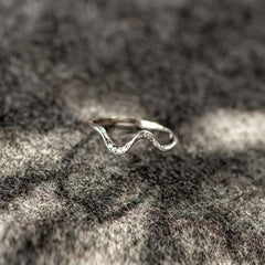 Silver water wave fashion ring with intricate design, showcasing flowing curves and a polished finish.