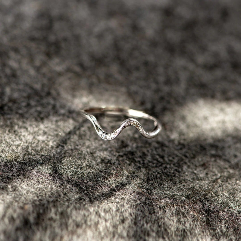 Silver water wave fashion ring with intricate design, showcasing flowing curves and a polished finish.