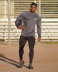 Black men's zipper neck fitness shirt with long sleeves, ideal for gym and sport activities. Perfect for active wear.