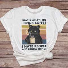 Female T-shirt with humorous cat drinking coffee graphic, casual pet-themed top, featuring a fun design and comfortable fit.