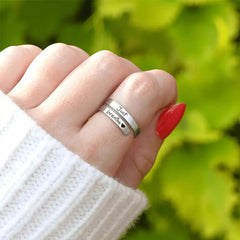 Silver spiral heart ring with intricate design, crafted from sterling silver, showcasing a delicate heart motif and smooth spiral band.