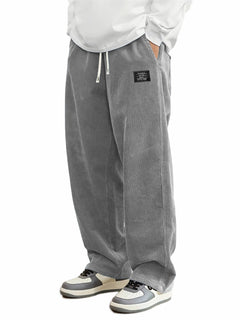 Men's relaxed-fit corduroy casual pants in a neutral color, displayed on a hanger with a plain background.