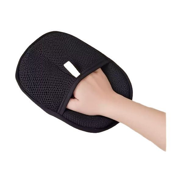 Pet grooming glove from My Store, showing a hand wearing the grooming glove with pet fur removal on the surface.
