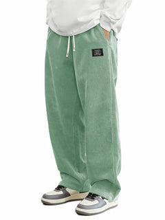 Men's relaxed-fit corduroy casual pants in a neutral color, showcasing comfortable fit and textured fabric.
