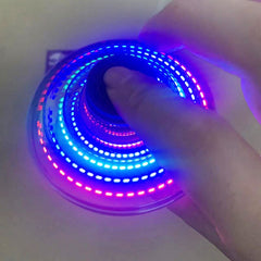 Mini UFO spinner drone in vibrant colors demonstrating spinning motion, compact design, and sleek appearance.