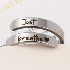 Silver spiral heart ring with intricate design, showcasing a shiny silver band and a delicate heart-shaped motif.