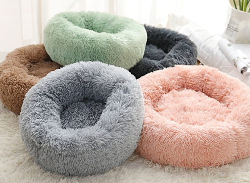 Round plush dog bed for small dogs and puppies, soft cushioning, and cozy design in neutral colors.