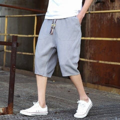 Mens casual loose linen cropped pants in natural beige color, featuring relaxed fit and lightweight fabric.