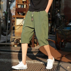 Men's casual loose linen cropped pants in light beige, featuring a relaxed fit and elastic waistband, displayed on a hanger.
