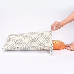 Cotton linen bread bag for storing bread, featuring a natural beige color and drawstring closure, ideal for eco-friendly kitchen storage.