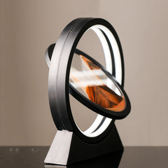 Moving sand art landscape table lamp with layered sand creating a scenic design in a clear glass container.