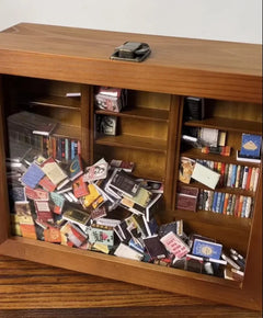 Anxiety bookshelf titled "Shake Away Your Anxiety" with colorful books and decorative plants on a wooden shelf.