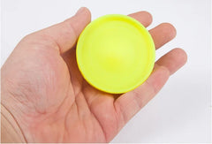 Mini flying disc catching game from My Store with colorful discs and a person playing outdoors.