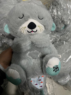 Soft plush otter sound machine toy with sensory lights, music, and rhythmic breathing motion for babies.